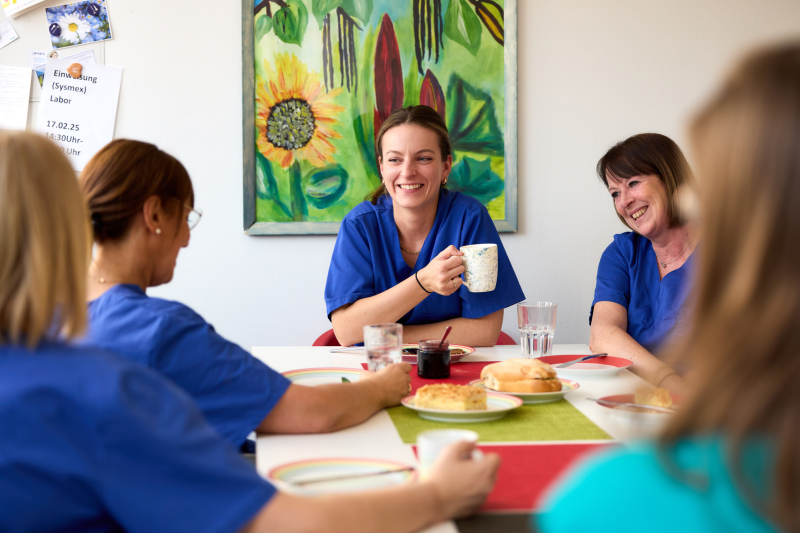 Das Team sitzt im Pausenraum