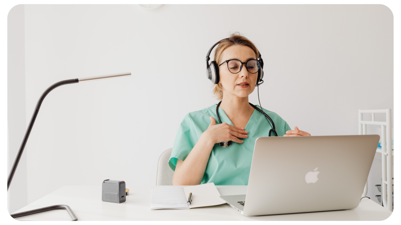 Ärztin, die an einem PC sitzt und einen Videoanruf macht