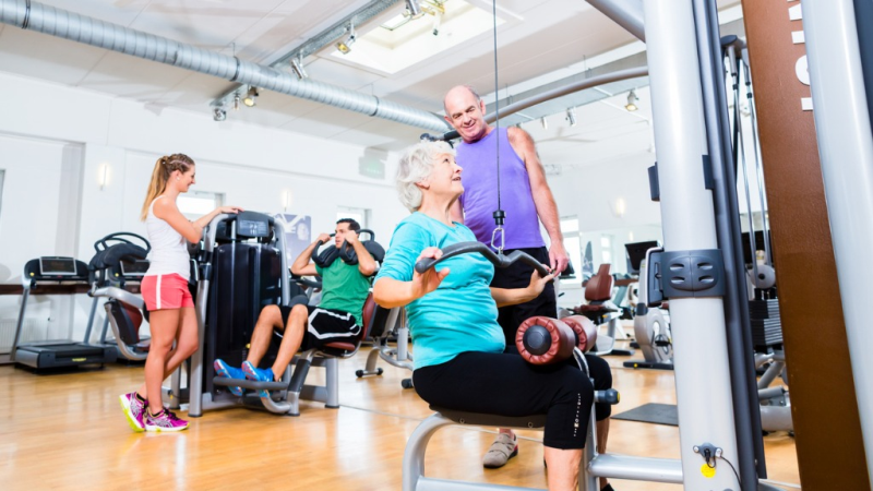 senior-woman-doing-back-training-with-trainer-